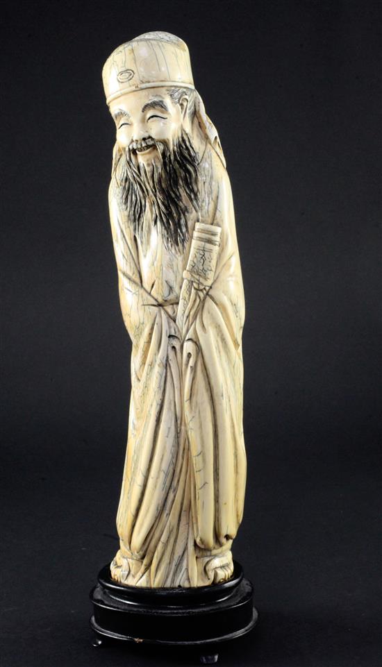 A Chinese mammoth ivory carving of an immortal, in Ming style, 20th century, 30cm, wood stand